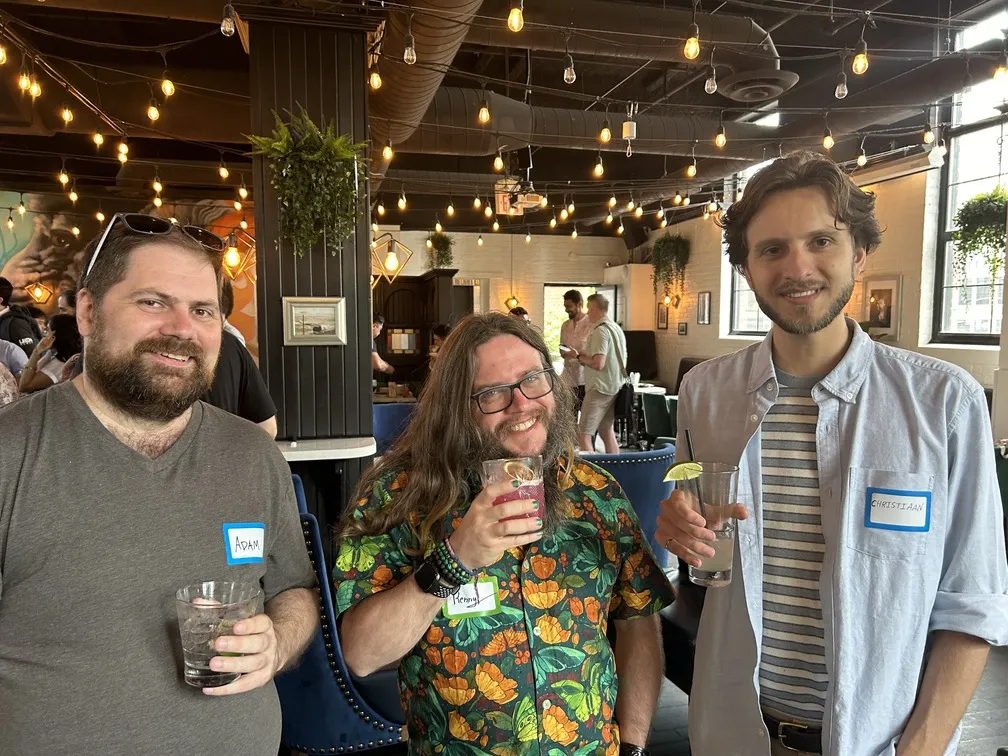 Quickhubly team members enjoying drinks at social event